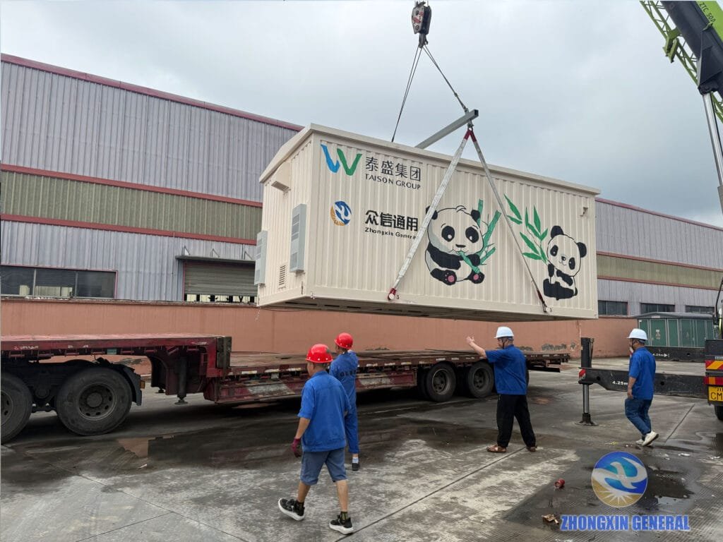 Second panda-liveried prefabricated cabin being lifted and loaded onto a truck