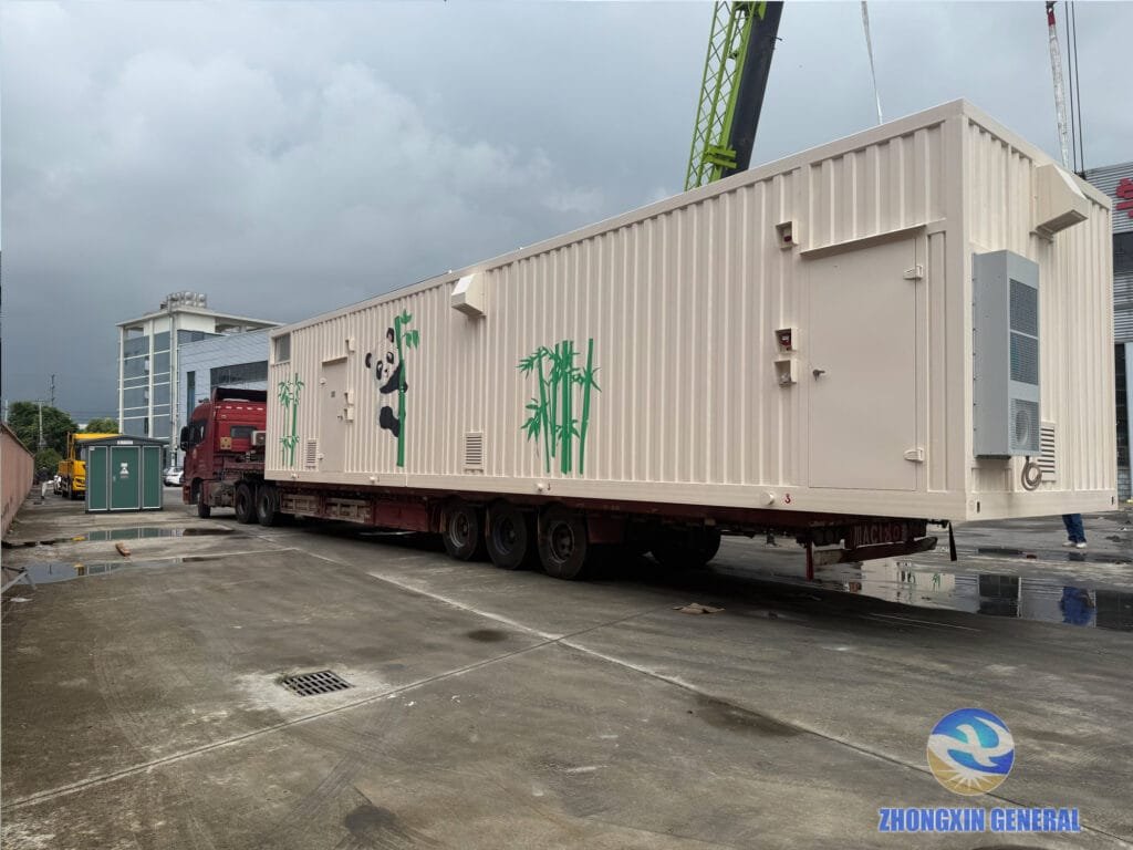 Loaded truck carrying a prefabricated cabin moving toward the yard for cargo securing