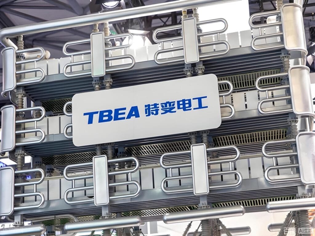 TBEA high-voltage power transformer on display at an industry exhibition, showcasing the company's flagship power transmission equipment with its signature silver cooling radiators and precision-engineered metal piping