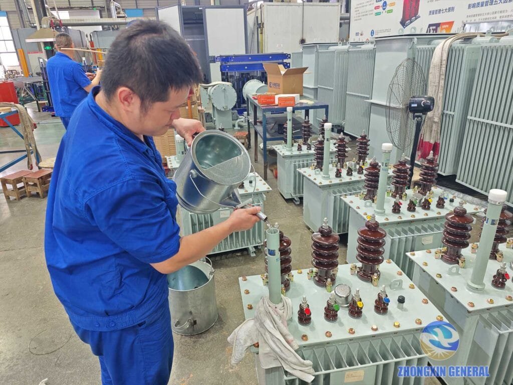 Operators performing oil filling on transformer tank