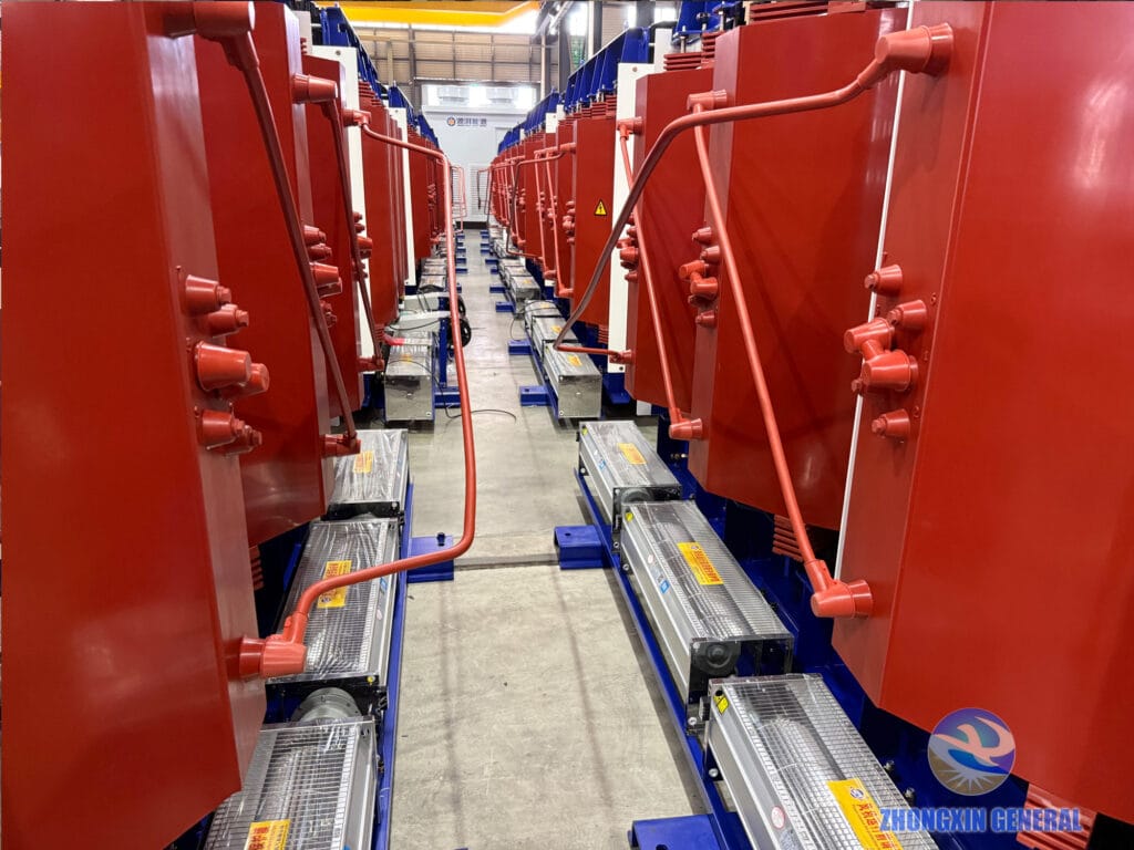 Rows of 5250 kVA dry-type transformers fitted with cross-flow cooling fans, ready for prefabricated cabin installation