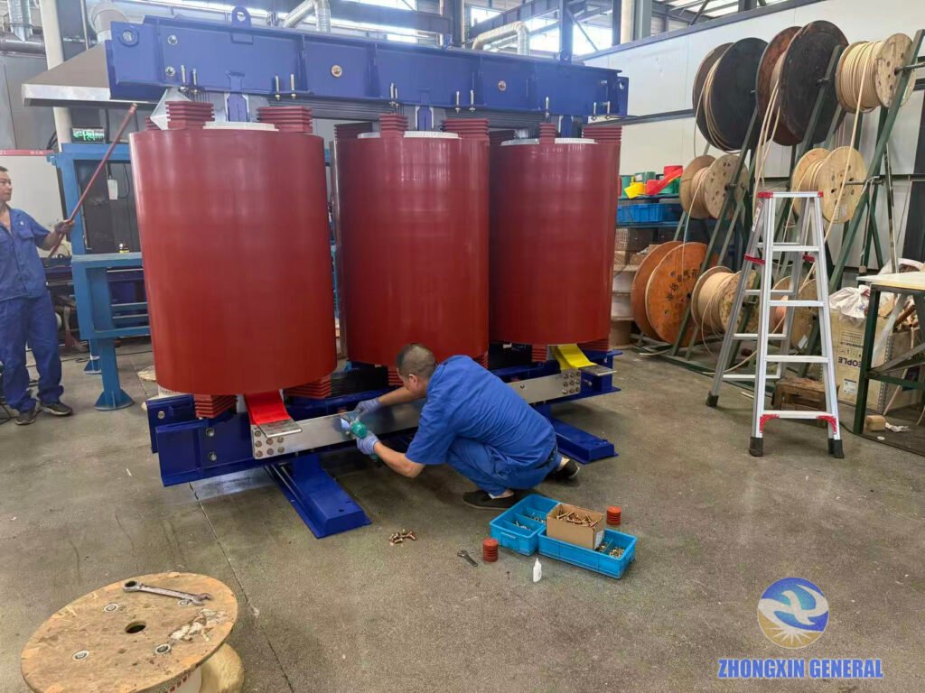 technician tightening busbar connections on 5250kVA dry-type transformer during assembly