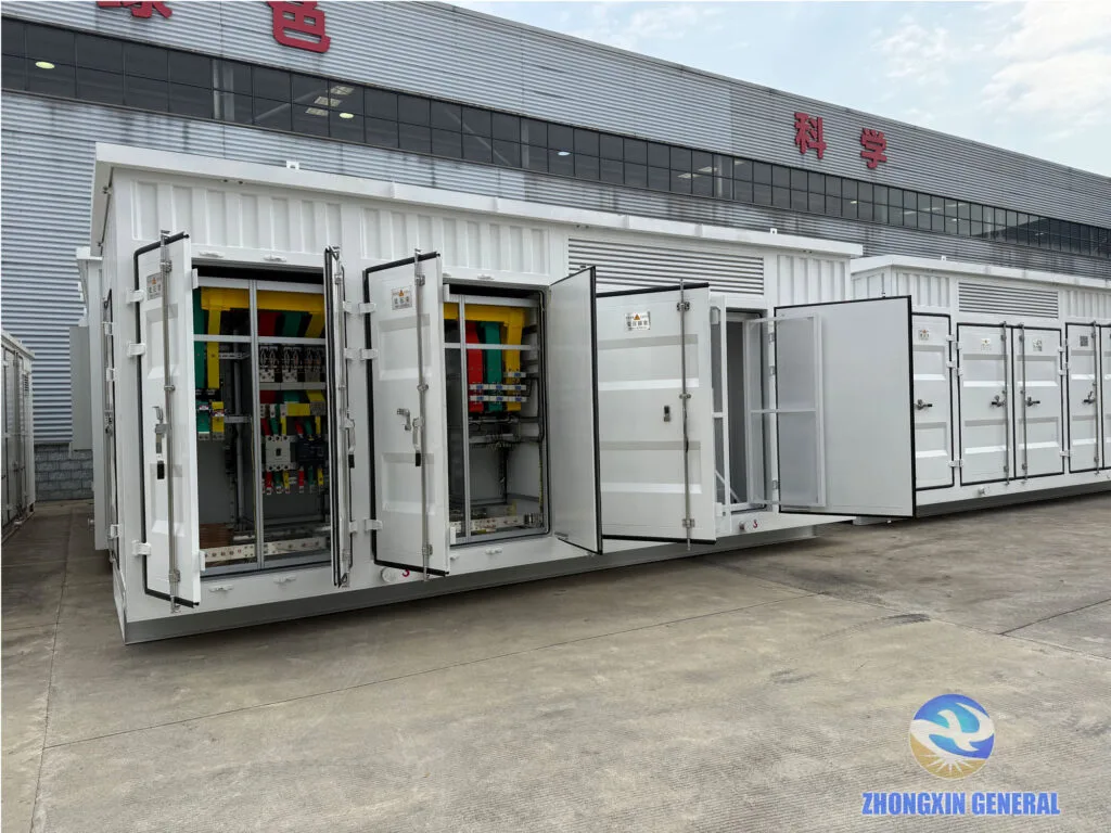 Row of white container-type prefabricated cabin substations outside ZHONGXIN GENERAL factory building ready for shipment