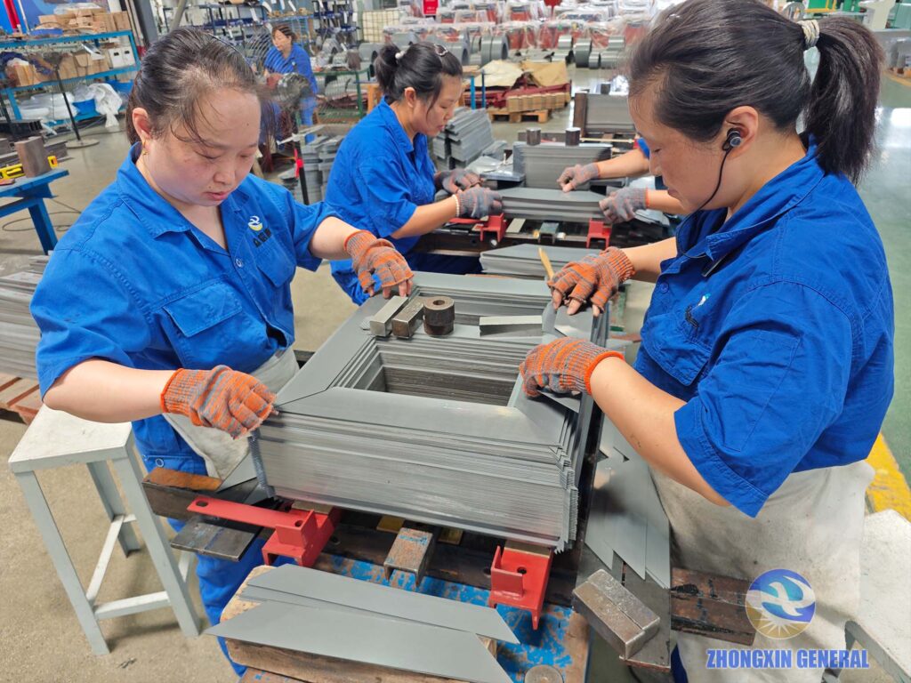 Two workers assembling silicon‑steel core for 250 kVA S11‑M‑250/10 oil‑immersed transformer