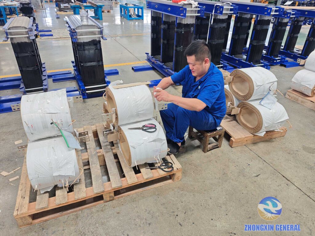 Technician wraps insulation tape on copper bar of 630 kVA oil‑immersed transformer winding Zhongxin General factory