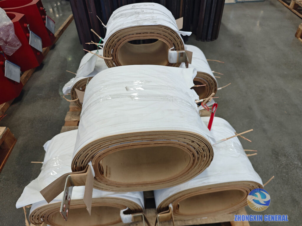 Completed winding assemblies for 630 kVA oil‑immersed transformers stacked inside Zhongxin General workshop