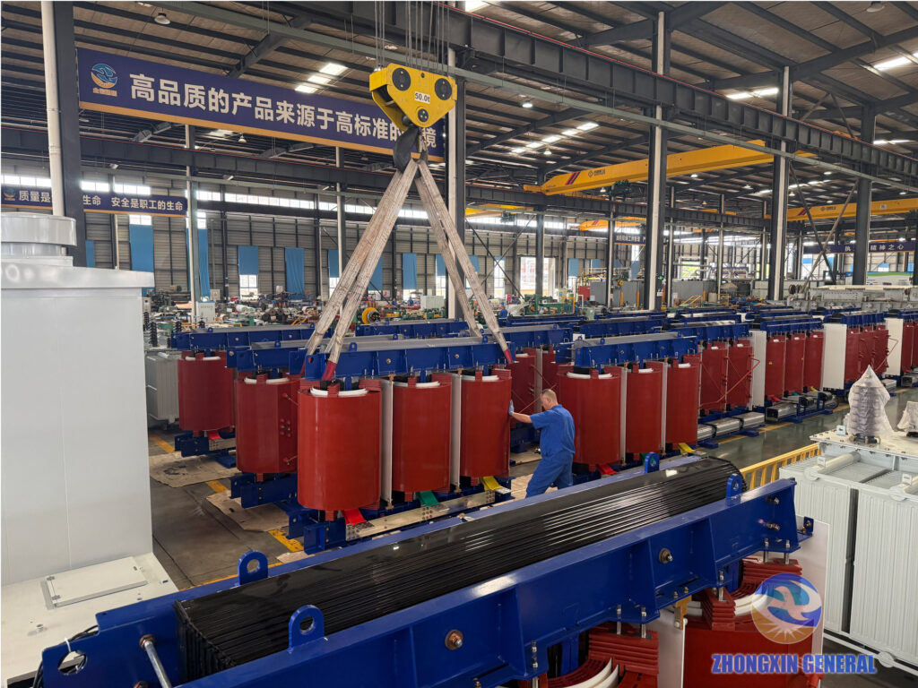 Overhead crane lifting cast-resin dry-type transformers on the ZHONGXIN GENERAL production floor during the National Day holiday