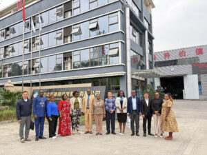 Group photo of the Ugandan Ambassador, embassy delegation and Zhongxin General staff at the factory gate in Chengdu